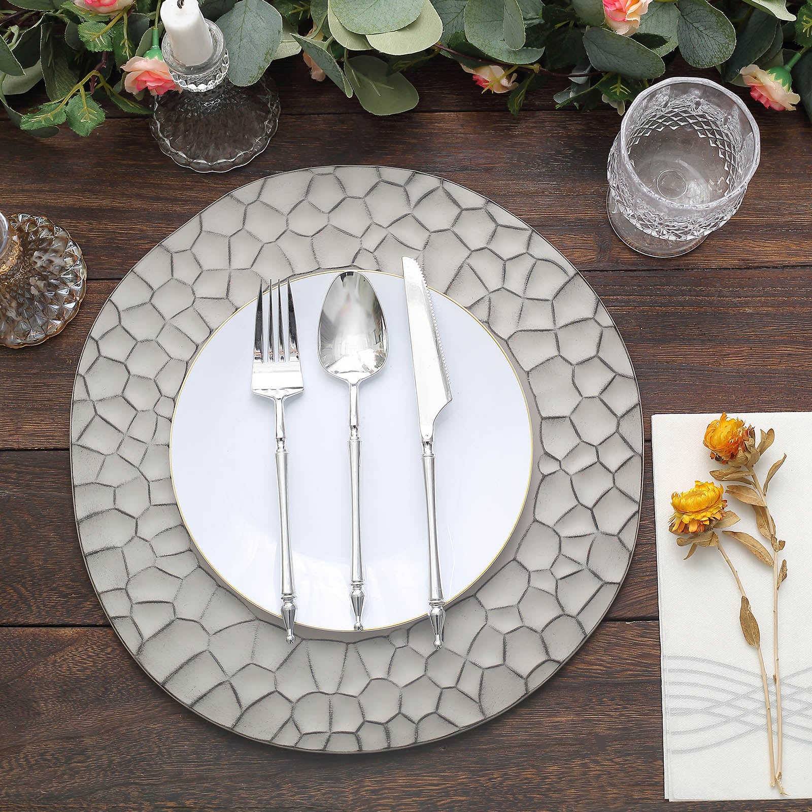 Matte gray hammered charger plate with modern dinnerware setting.