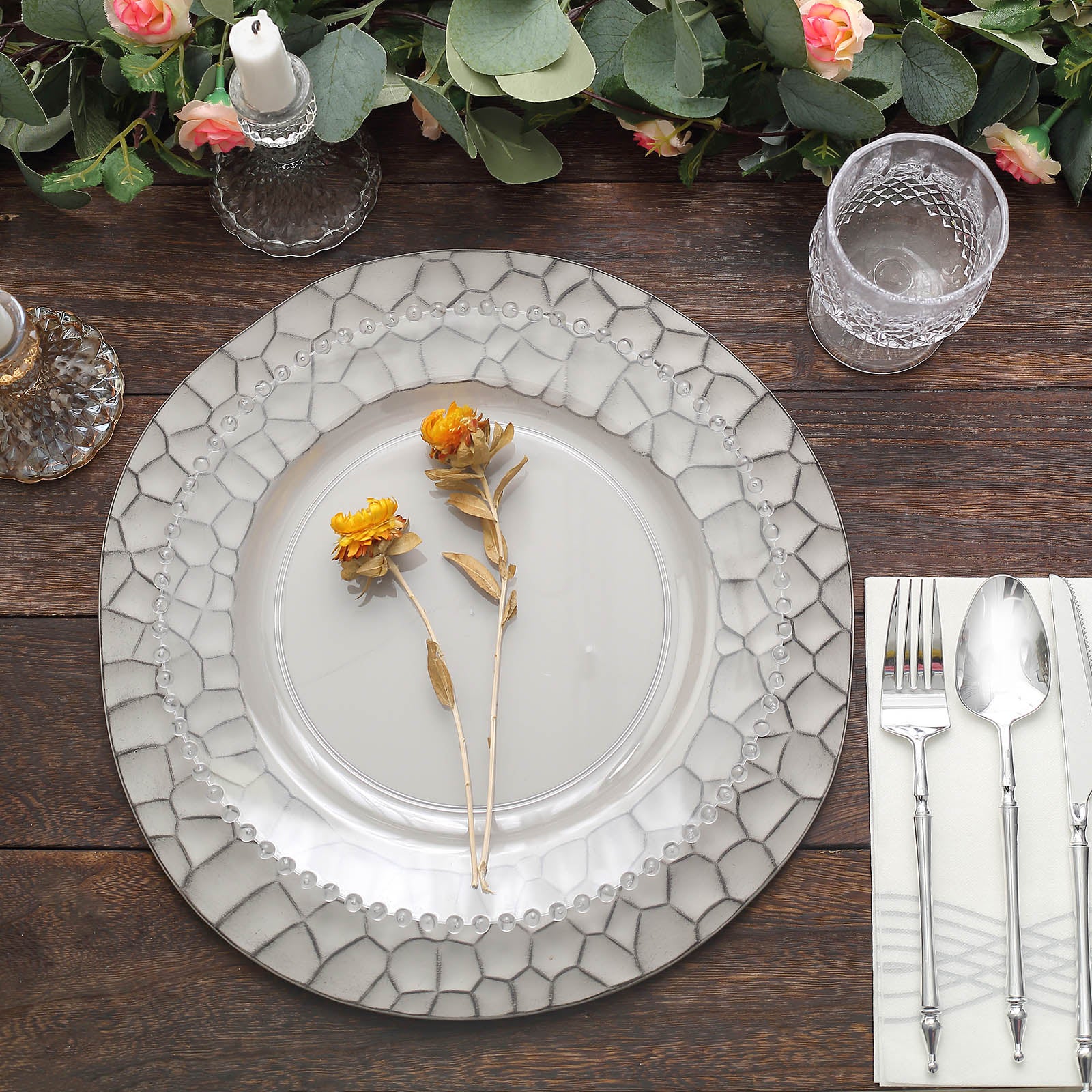 Matte gray hammered charger plates with floral decor and elegant table setting.