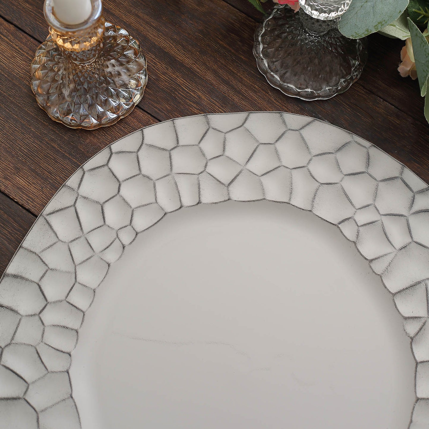 Matte finish gray hammered charger plate on a wooden table.