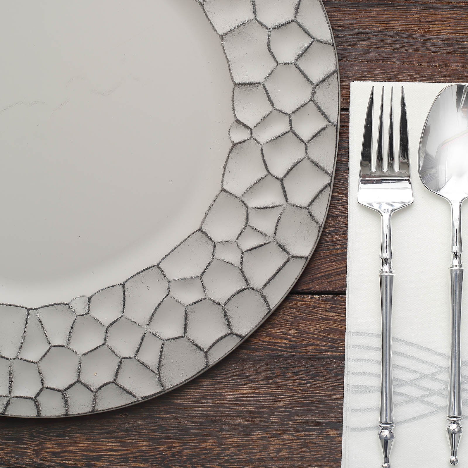 Matte finish gray hammered charger plate with modern design.