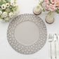 Matte finish gray hammered charger plate on a table with flowers and utensils.