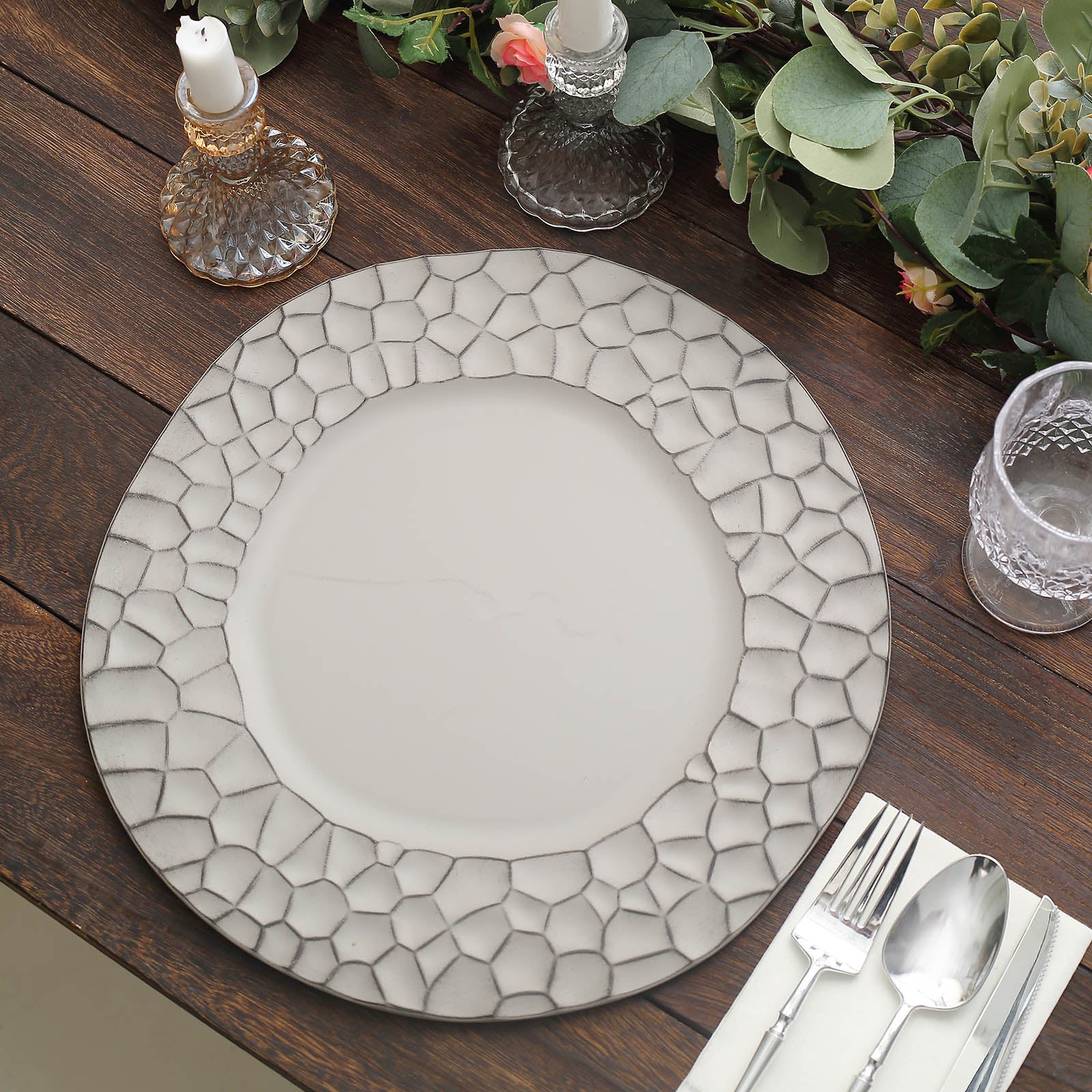 Matte gray hammered charger plate on a wooden table setting.