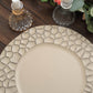 Matte finish taupe hammered charger plate on a wooden table.