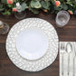 Elegant white plate on textured placemat with glassware and silver cutlery.