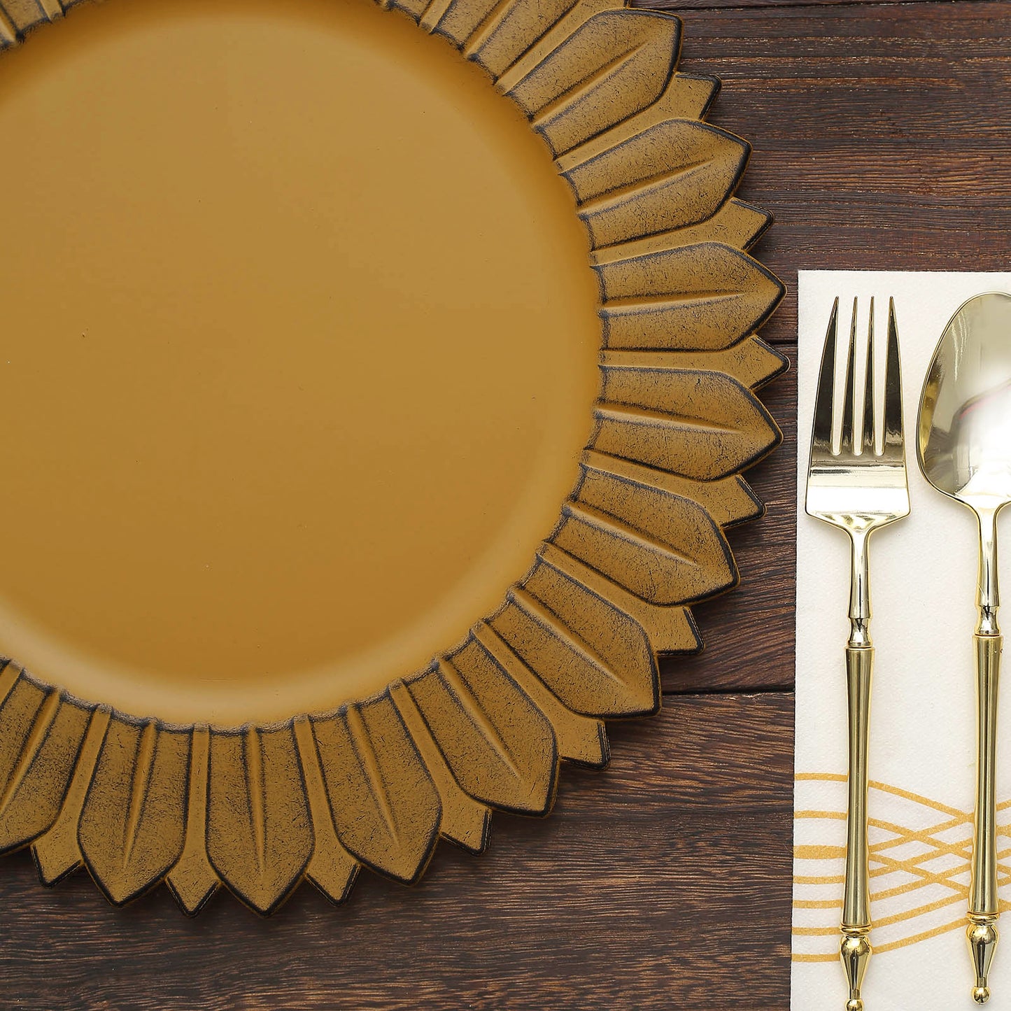 Matte mustard yellow sunflower disposable charger plate on a wooden table.