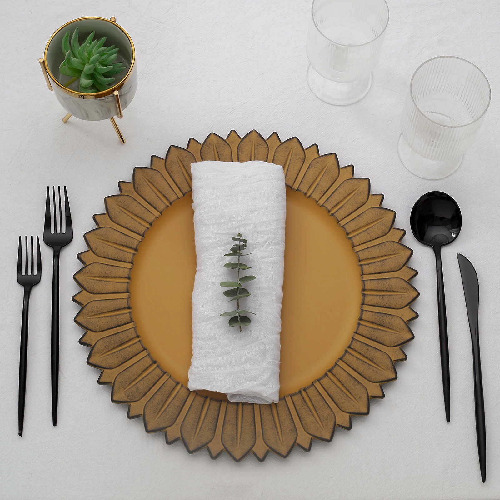 Matte mustard yellow sunflower charger plate with napkin and cutlery.