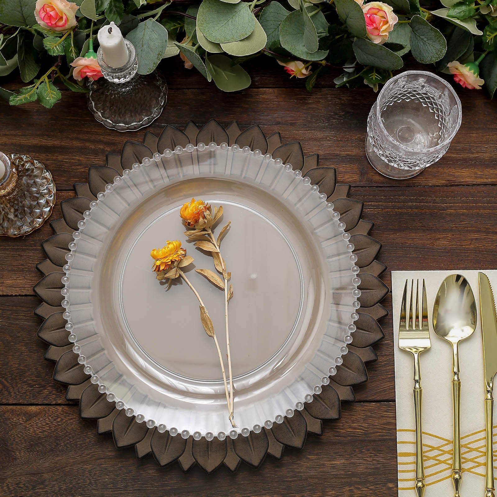 Matte natural sunflower disposable charger plates on a wooden table.