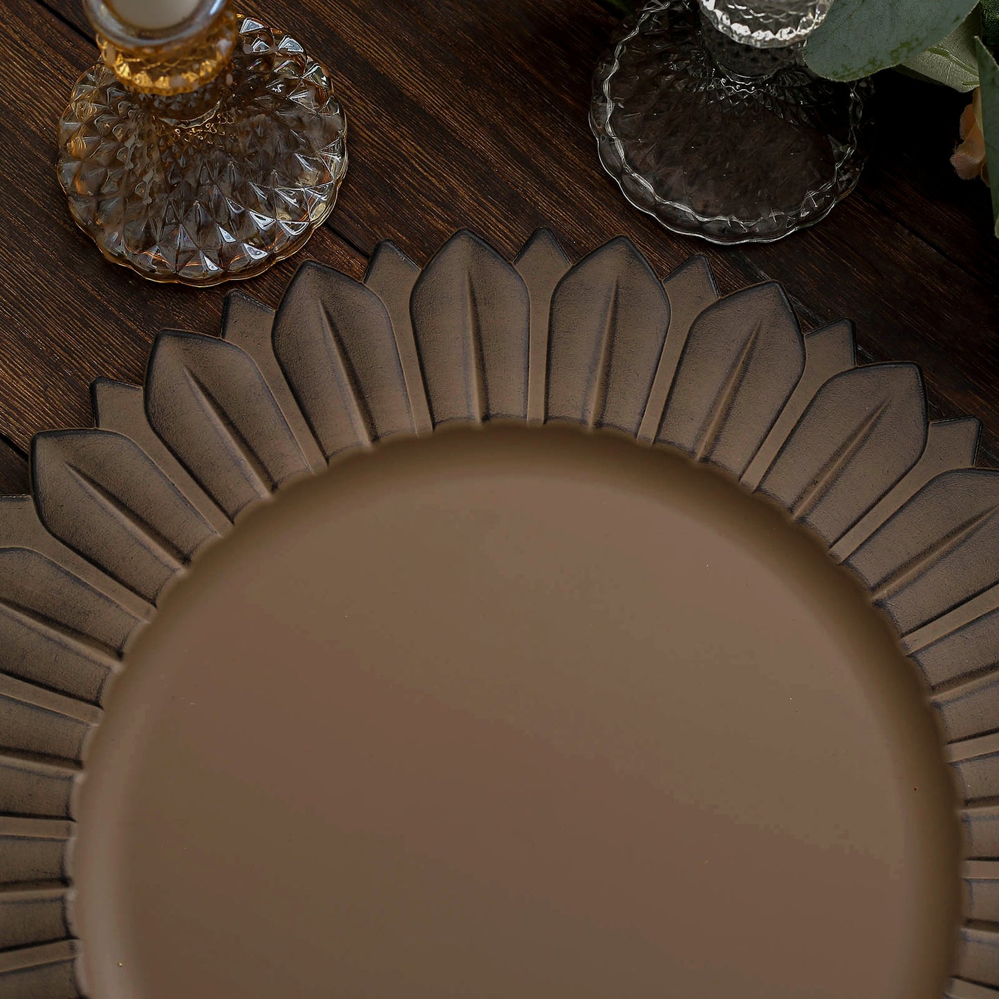 Matte natural sunflower disposable charger plate on a wooden table.