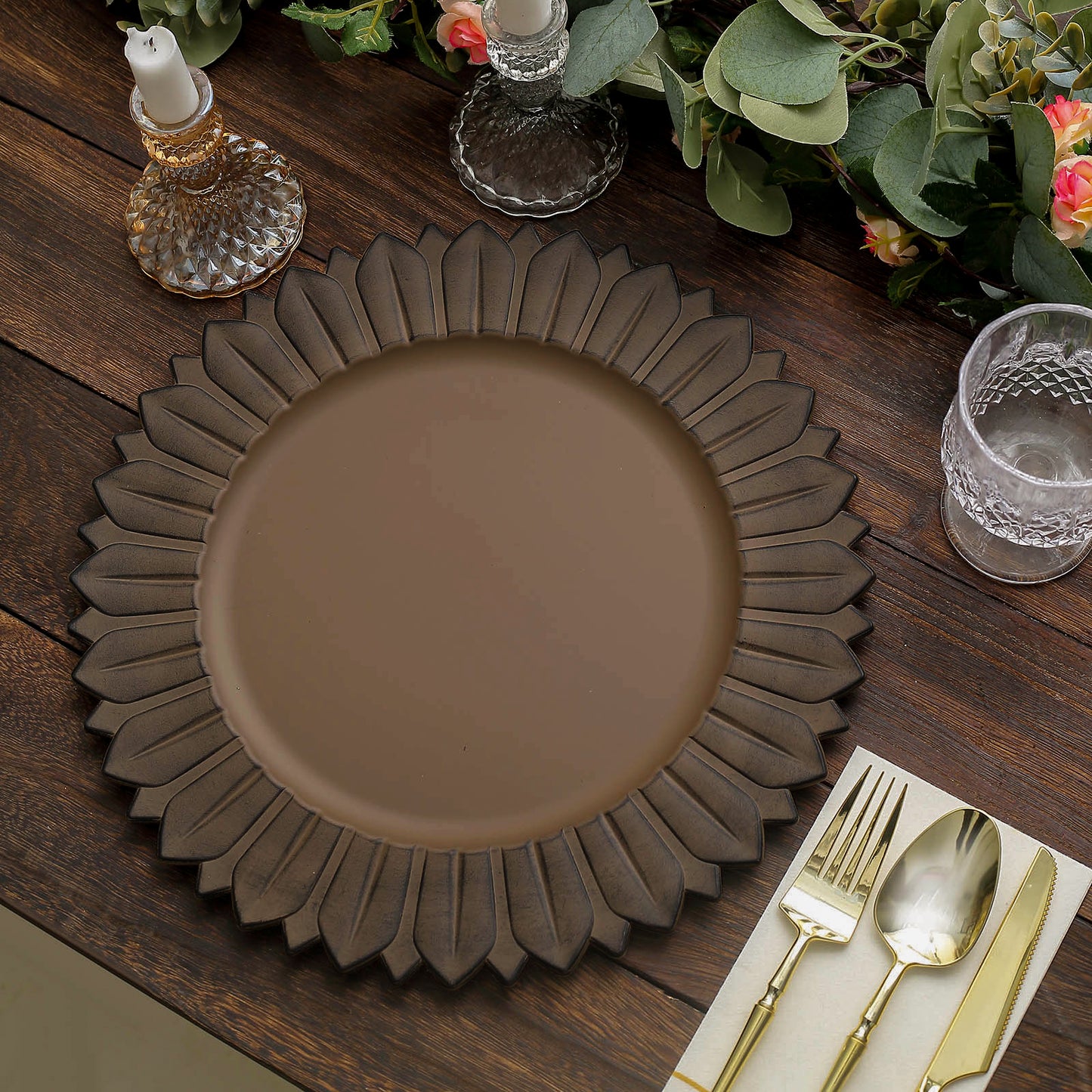Matte natural sunflower disposable charger plate on a wooden table setting.