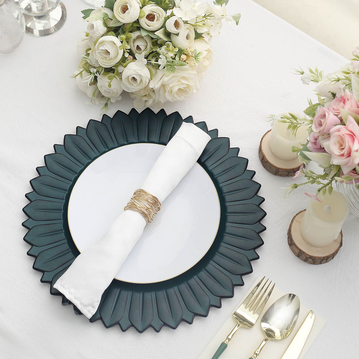 Matte teal sunflower charger plate on a dining table setting.