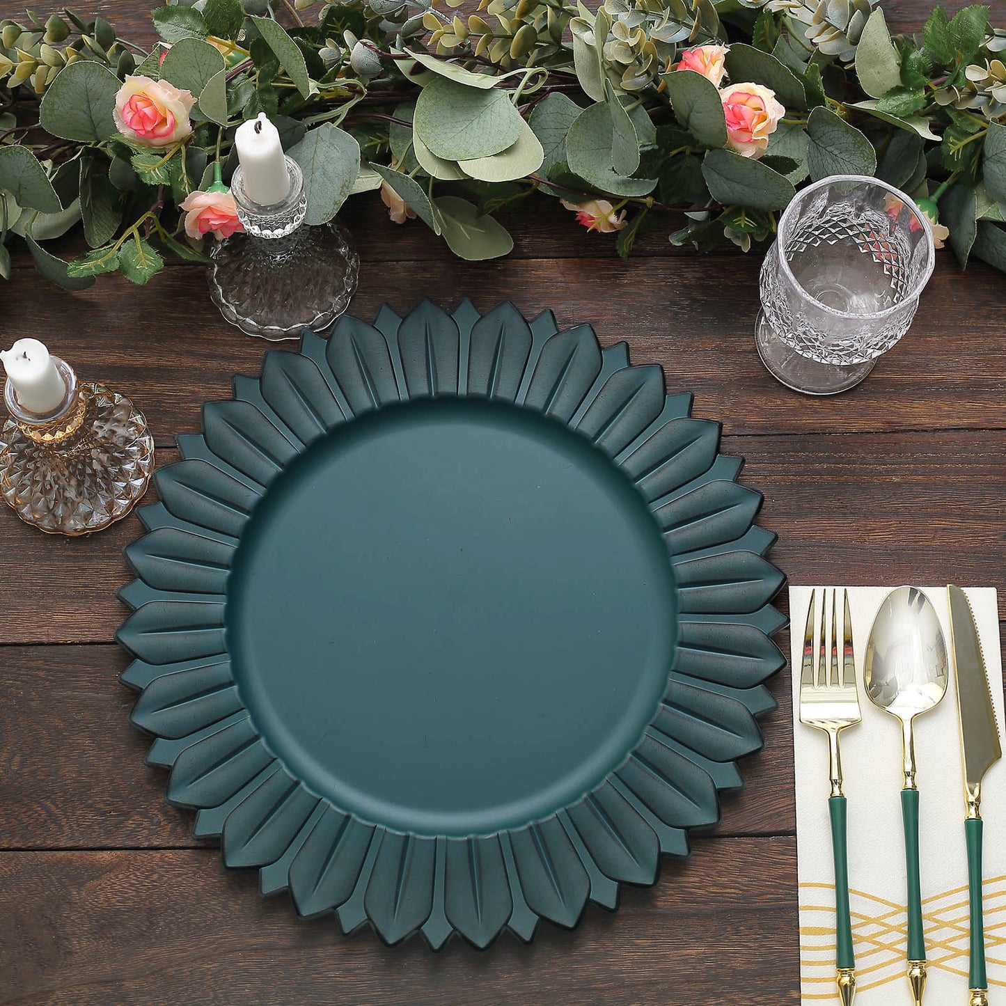 Matte teal sunflower disposable charger plate on a wooden table.