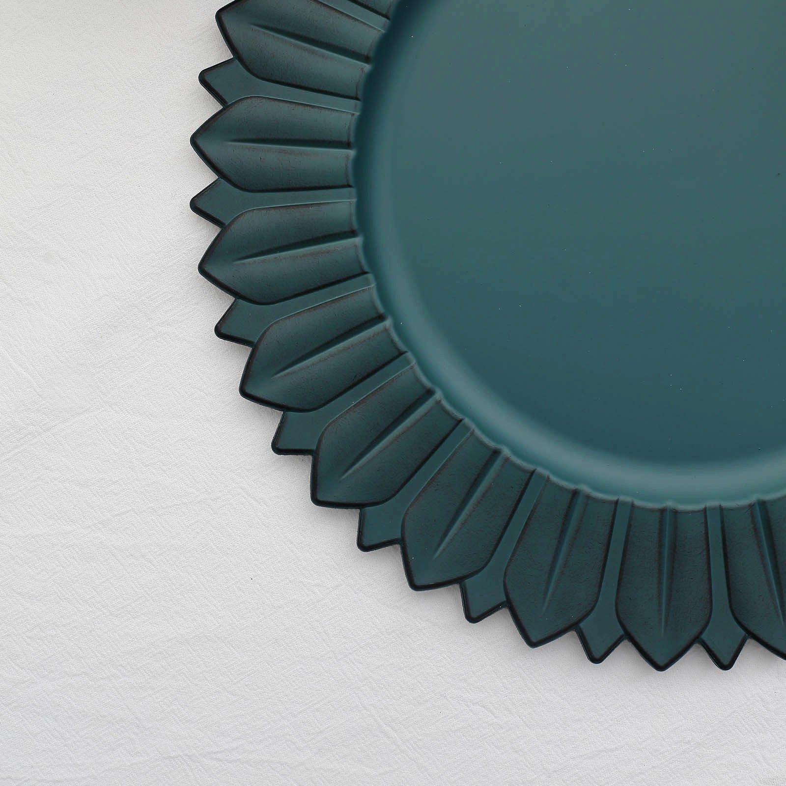 Matte teal sunflower disposable charger plate on a white background.