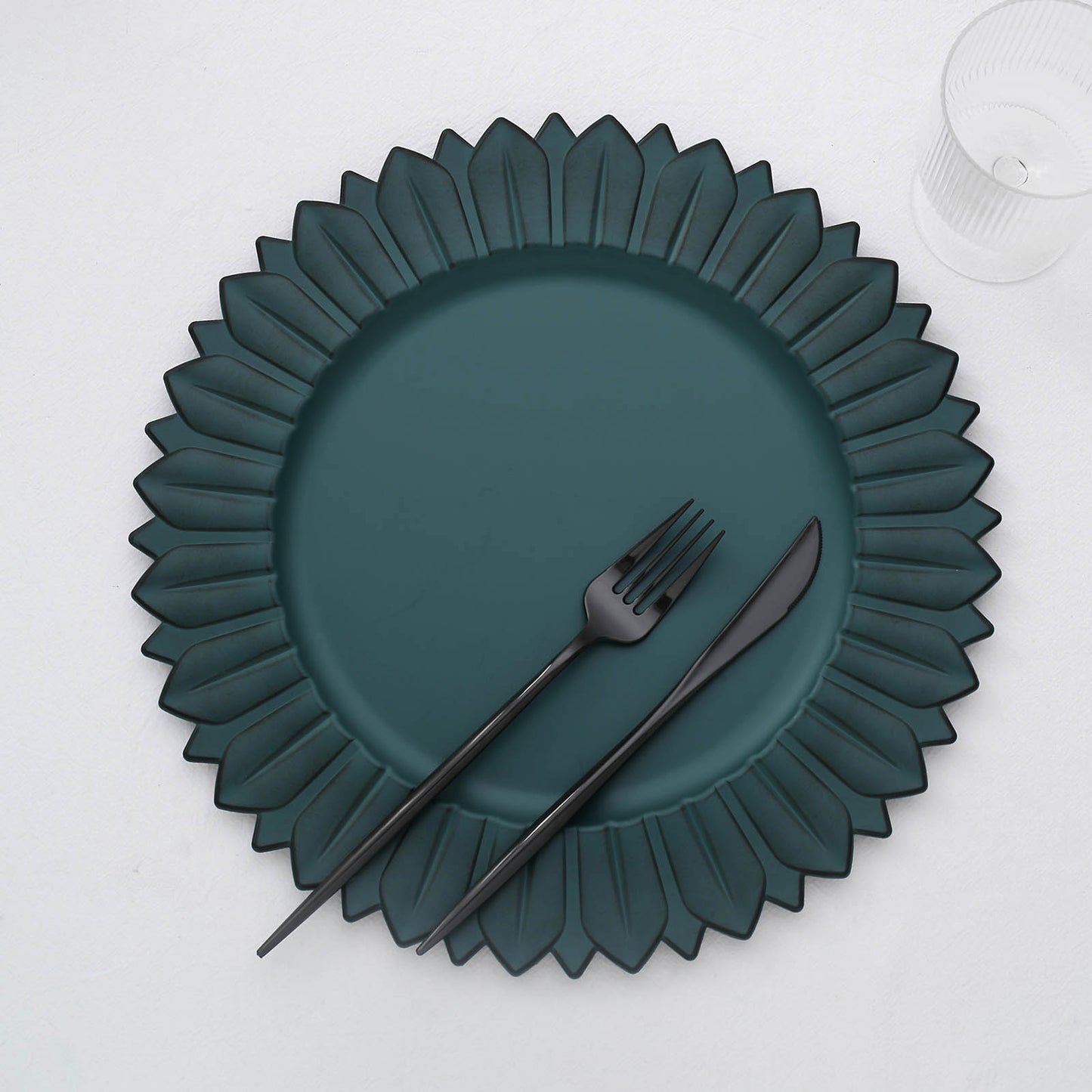 13" Matte Teal Sunflower Disposable Charger Plate with black utensils.