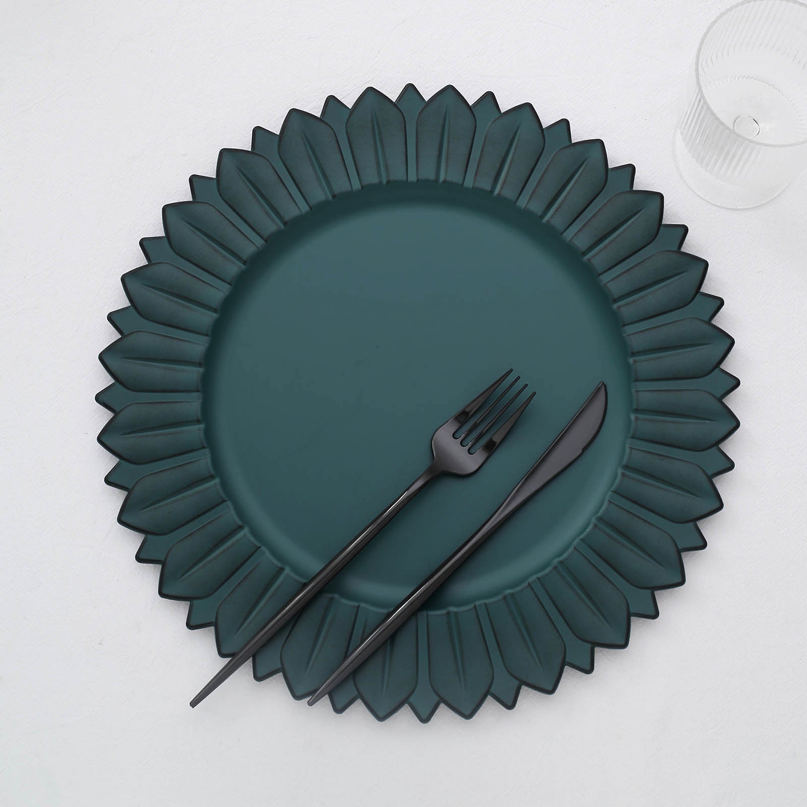 13" Matte Teal Sunflower Disposable Charger Plate with black utensils.