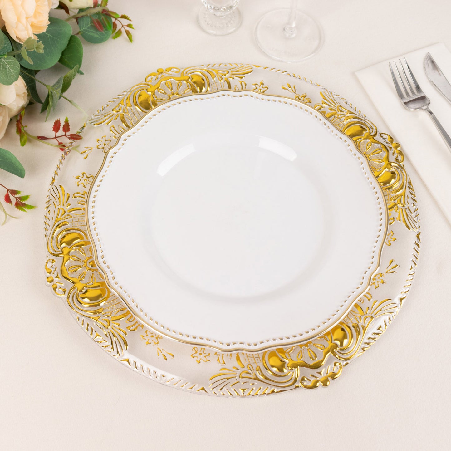 Clear decorative charger plate with gold embossed rim, 13" round.