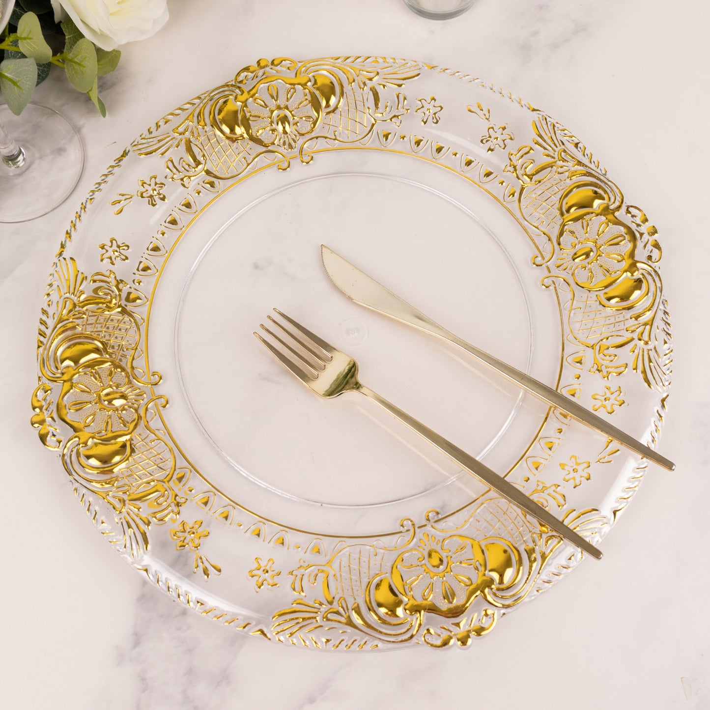 Clear decorative charger plate with gold embossed rim, 13" round.