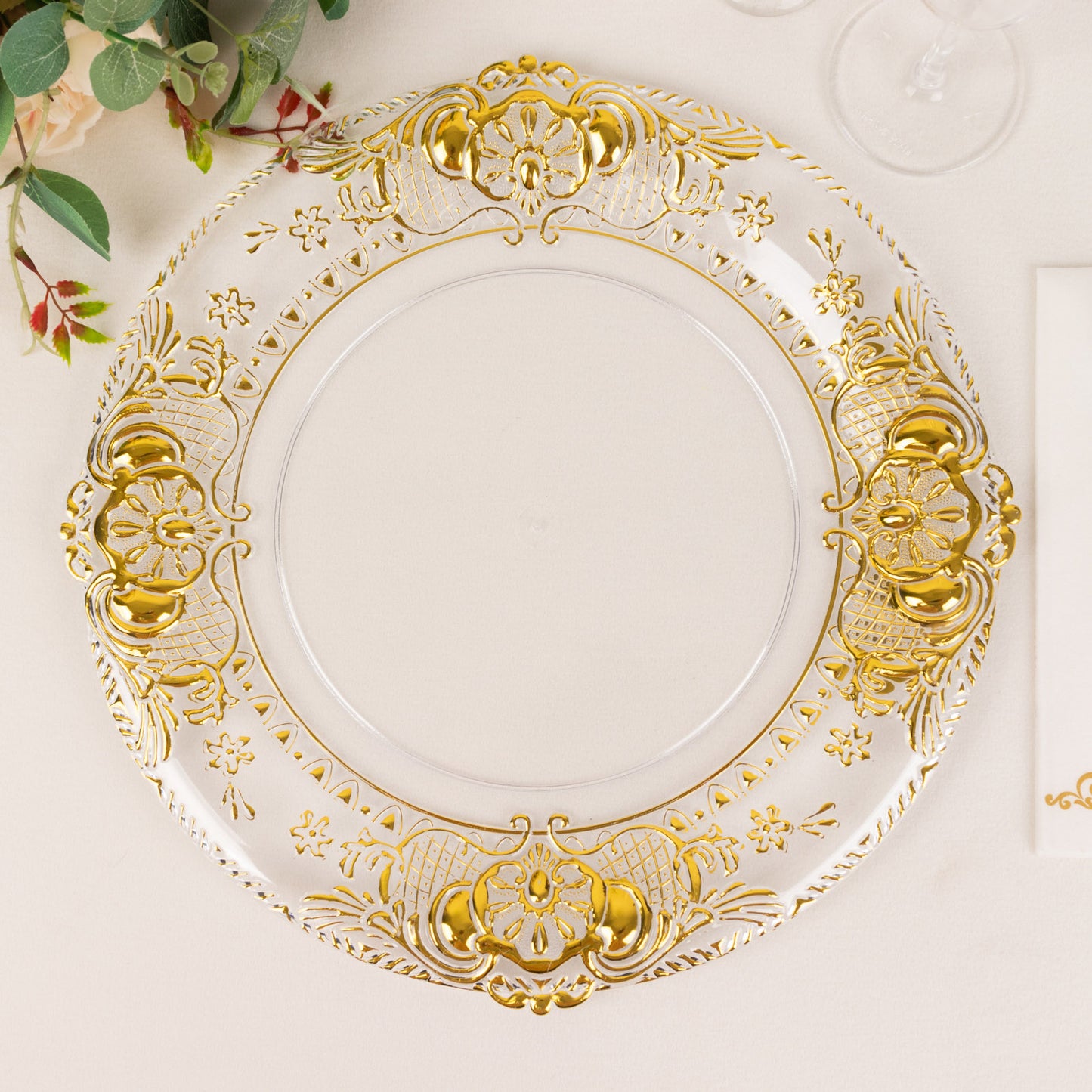 Clear decorative charger plate with gold embossed rim.