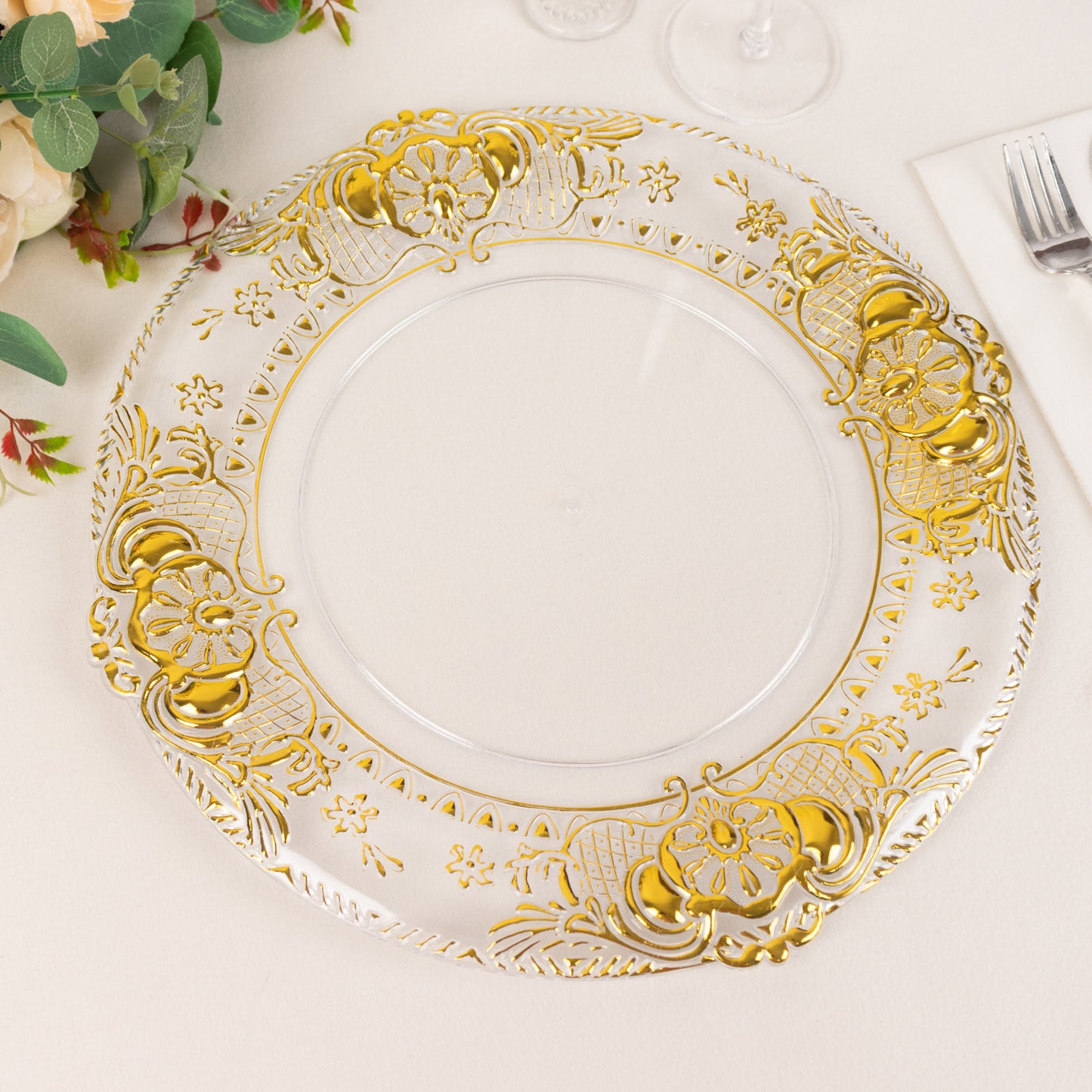 Clear decorative charger plate with gold embossed rim, 13" round.