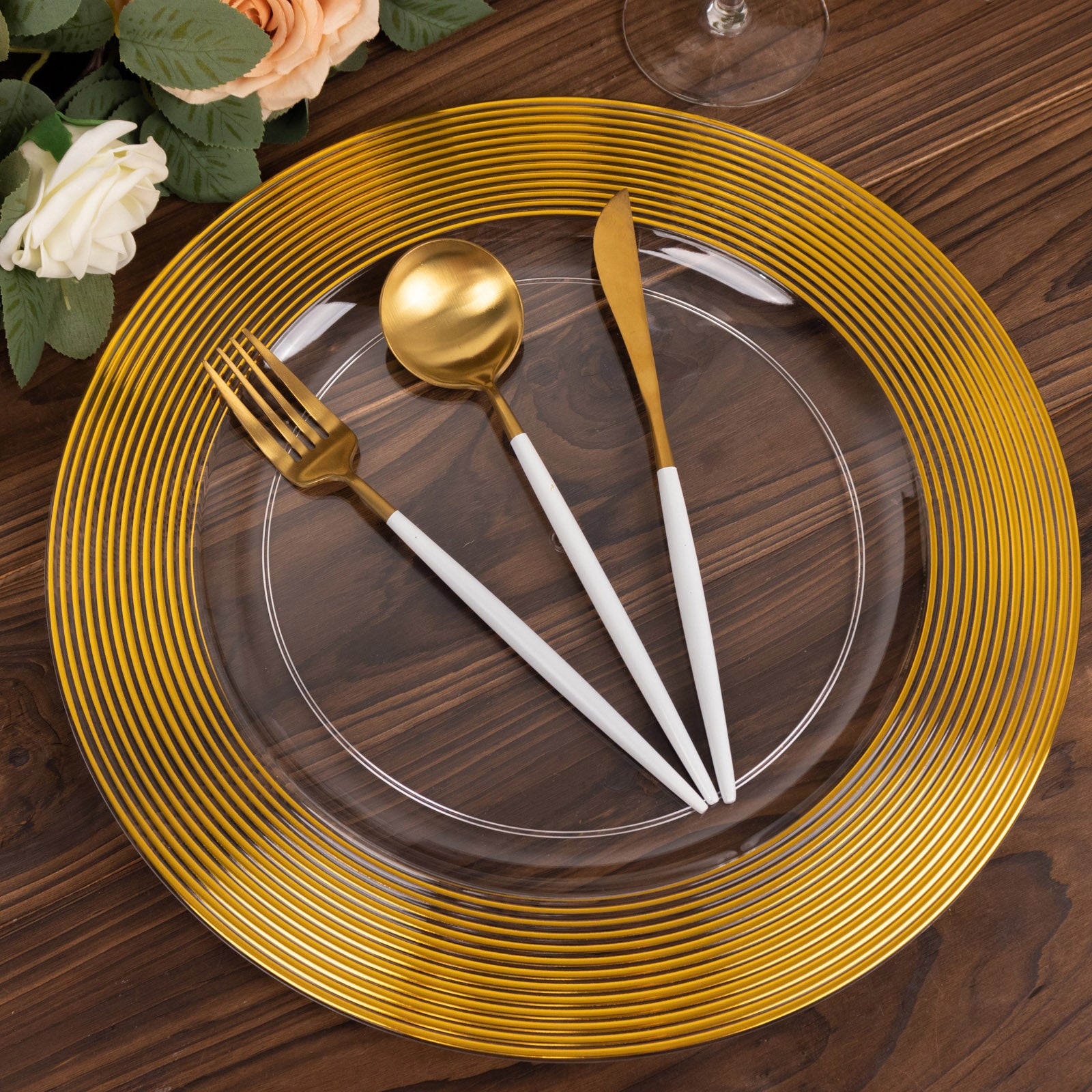 13" clear disposable charger plate with a gold lined rim, elegant for weddings.