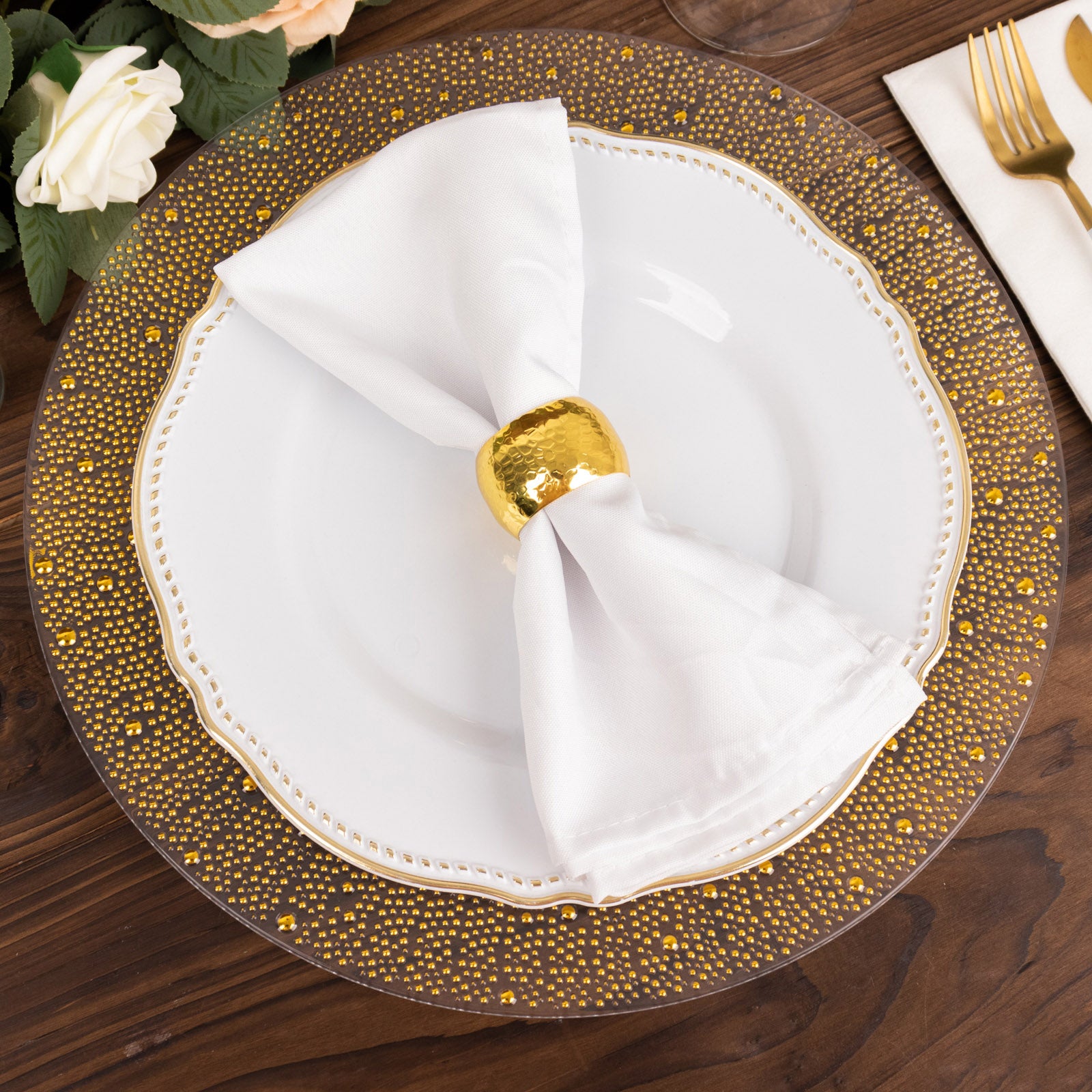 Clear and gold pearl beaded disposable wedding charger plate with dotted rim.
