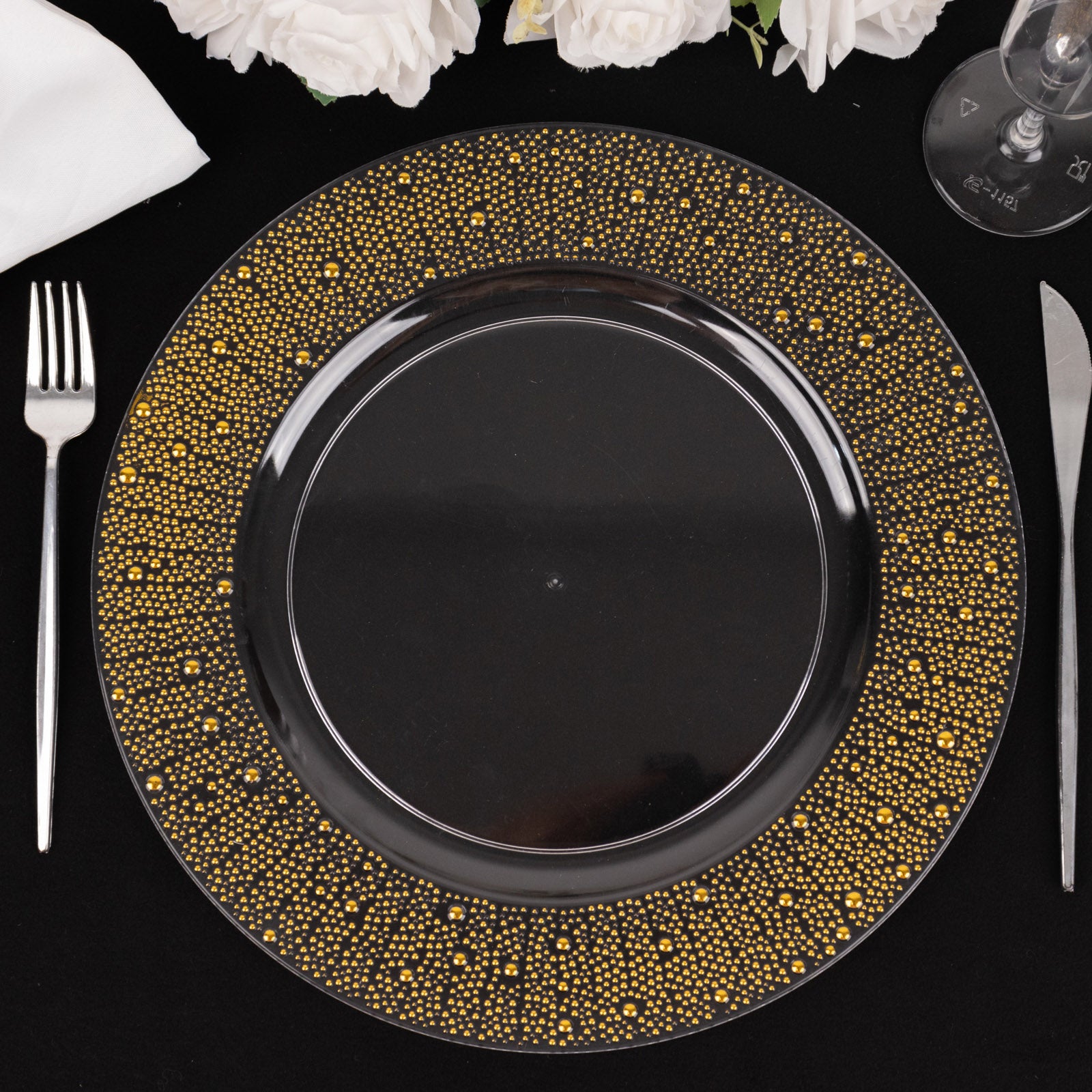 Clear and gold pearl beaded disposable wedding charger plate on a table setting.