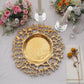 Gold acrylic charger plate with a decorative lace design.