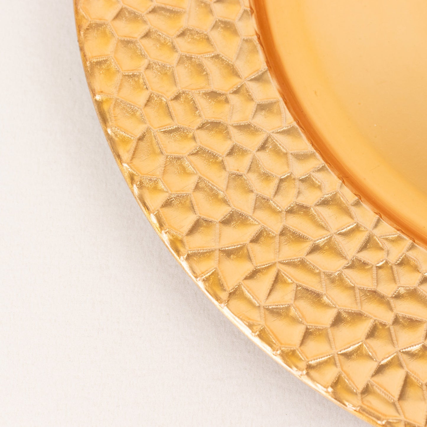 Metallic gold acrylic dinner serving plate with hammered rim.