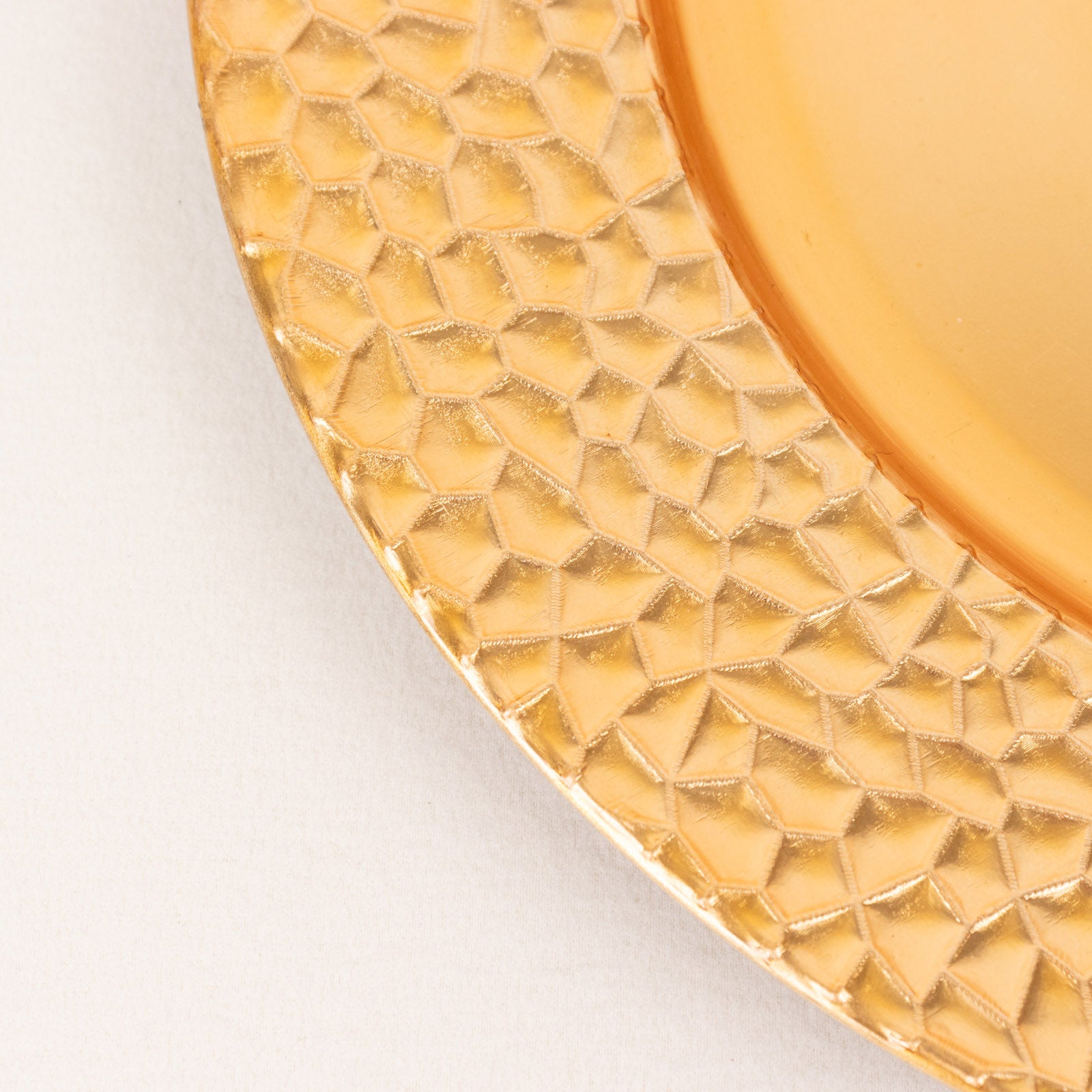 Metallic gold acrylic dinner serving plate with hammered rim.