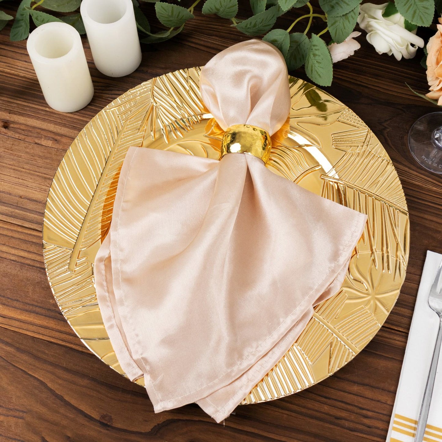 Metallic gold acrylic charger plate with embossed tropical leaves.