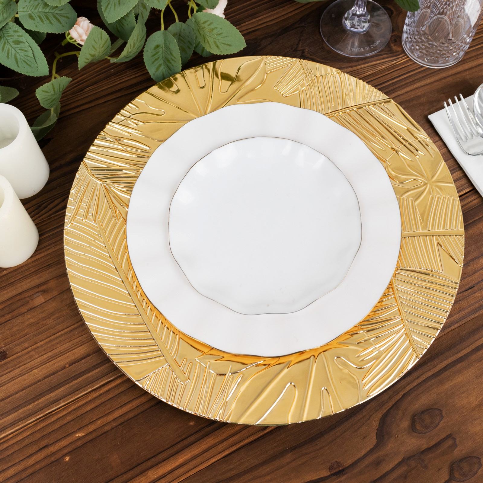 Metallic gold charger plate with embossed tropical leaves, 13" round decorative serving plate.
