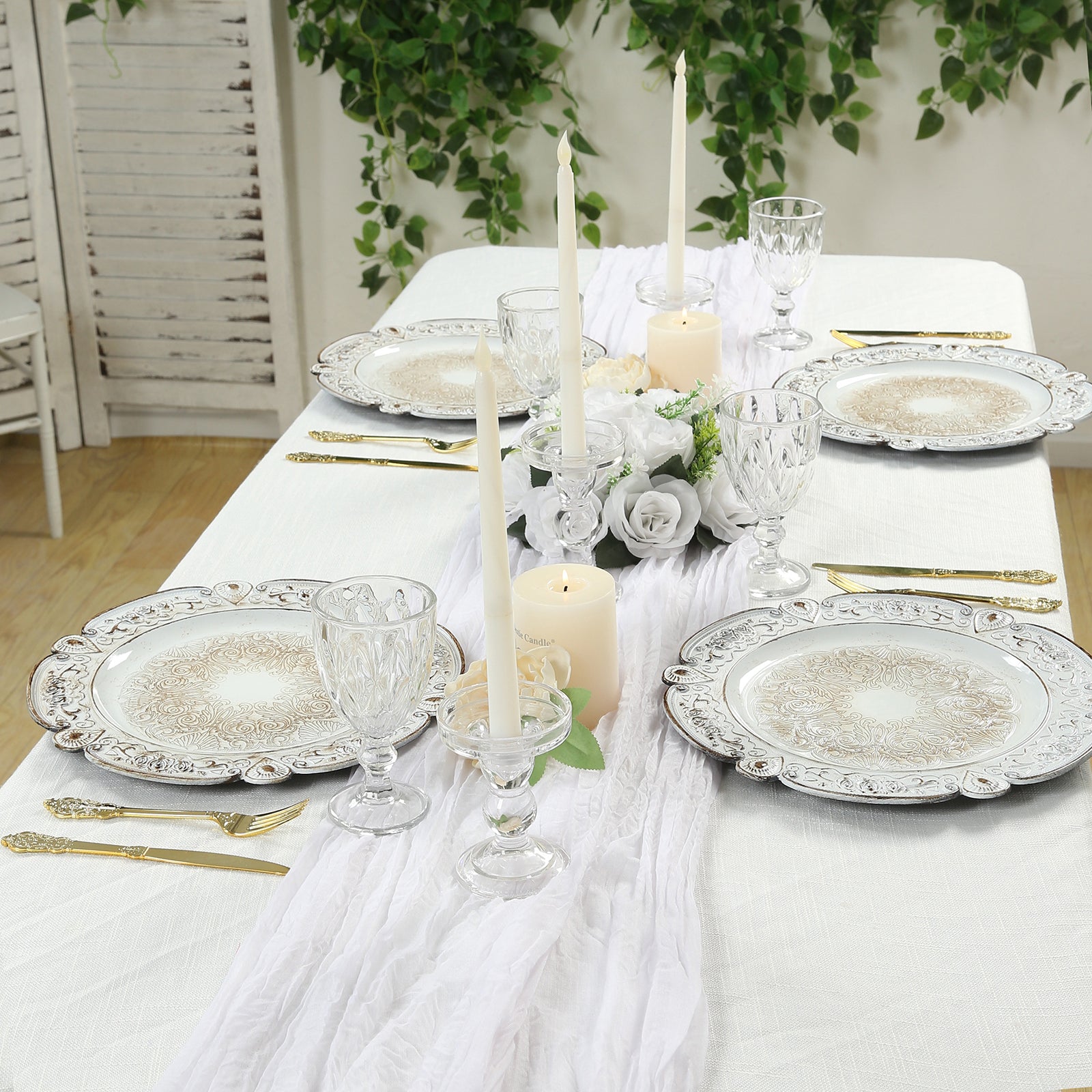 Antique white round acrylic charger plates with floral embossed design on a table setting.