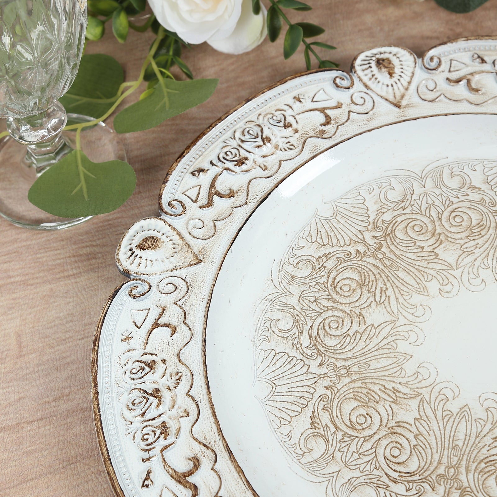 Antique white round acrylic charger plate with floral embossed rim.