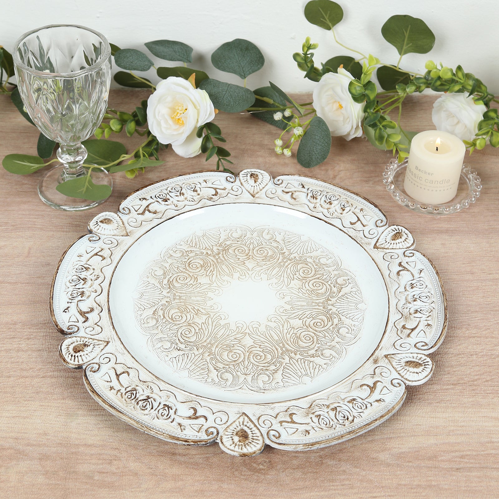 Antique white round acrylic charger plate with floral embossed rim.