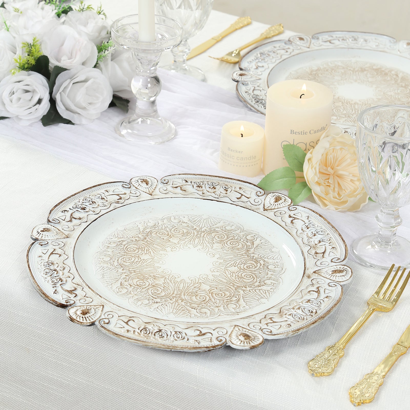 Antique white round acrylic charger plates with floral embossed rim.