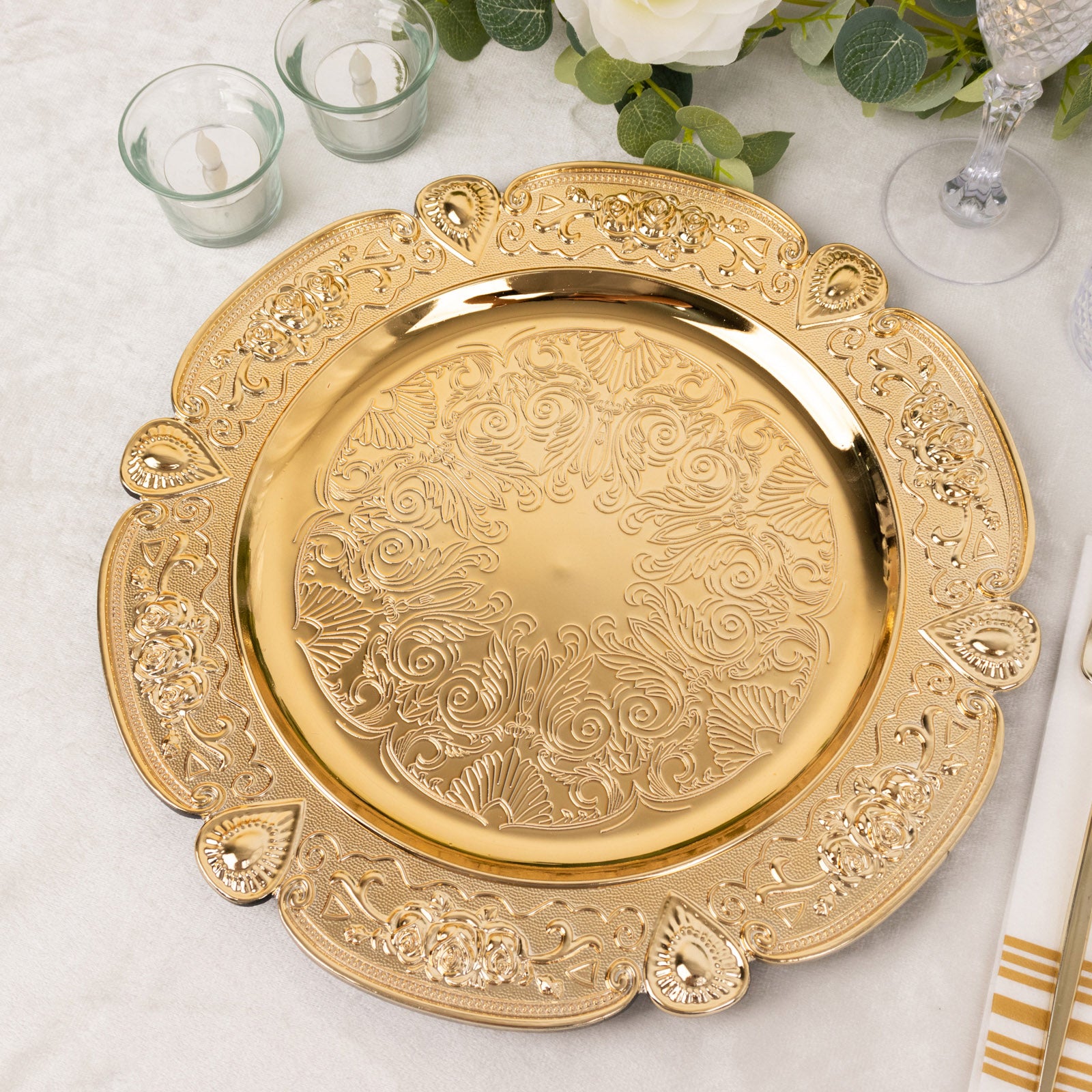 Gold round acrylic charger plate with floral embossed scalloped rim.