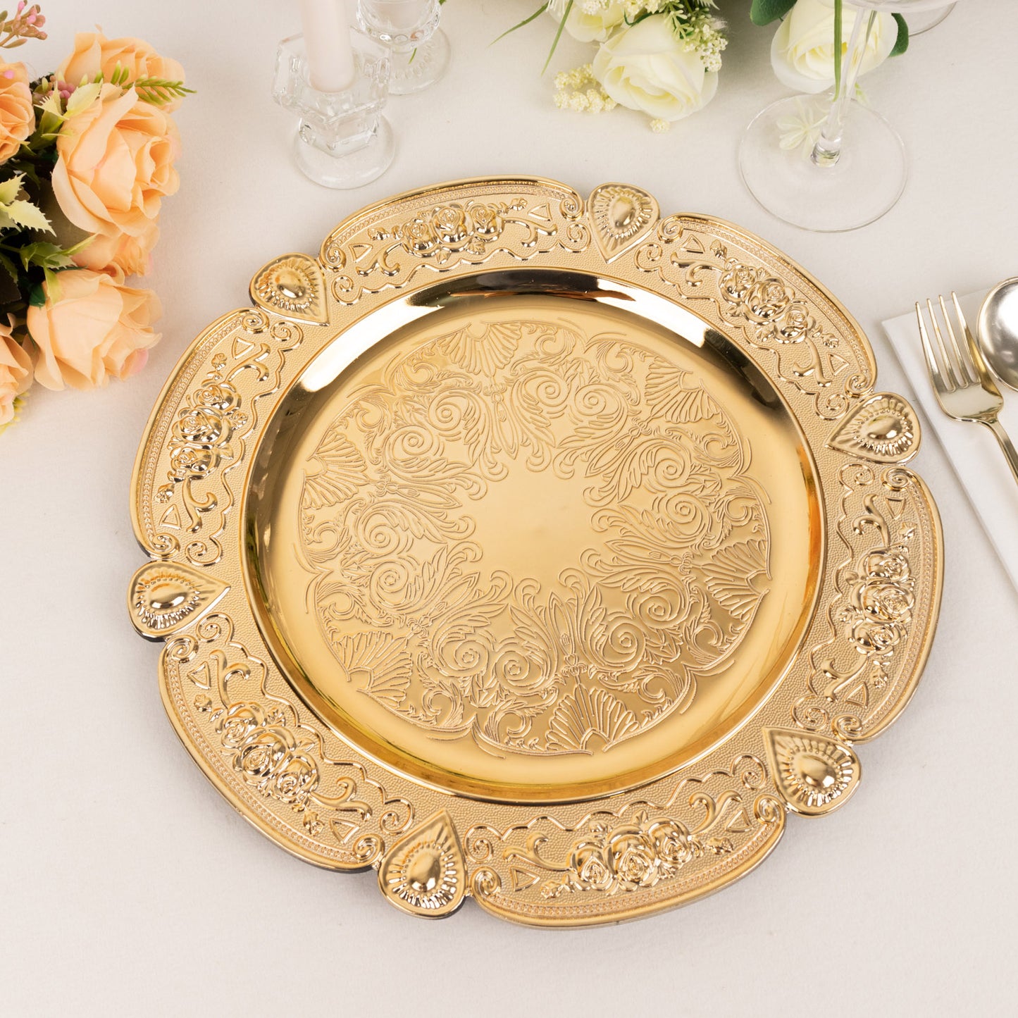 Gold round acrylic charger plate with floral embossed scalloped rim.