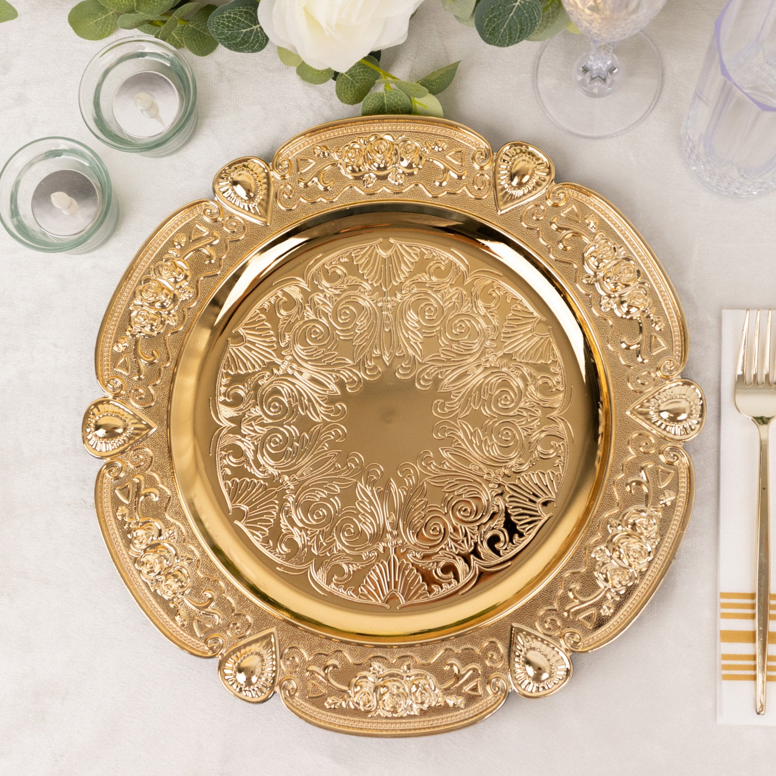 Gold round acrylic charger plate with floral embossed scalloped rim.