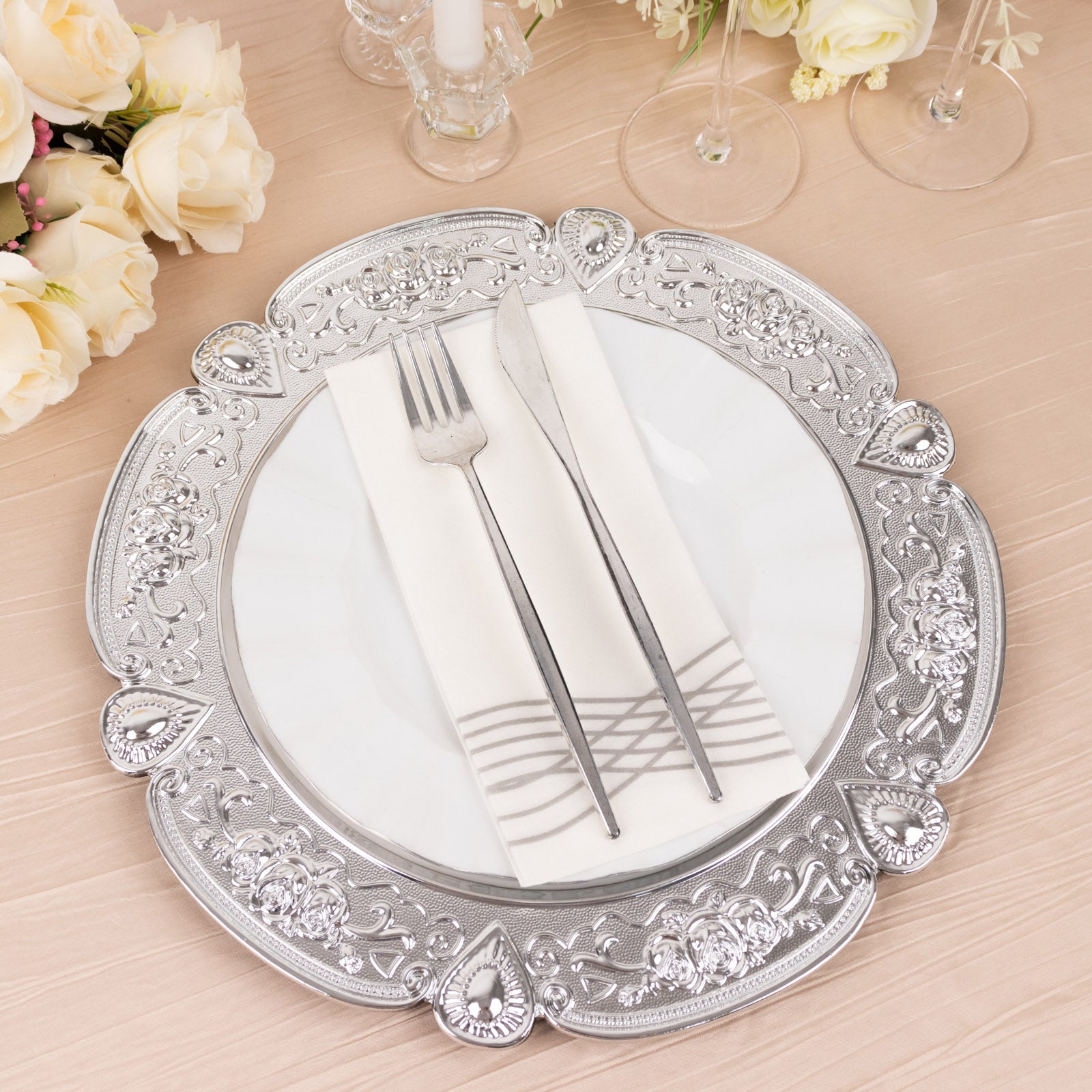 Silver round acrylic charger plate with floral embossed scalloped rim.