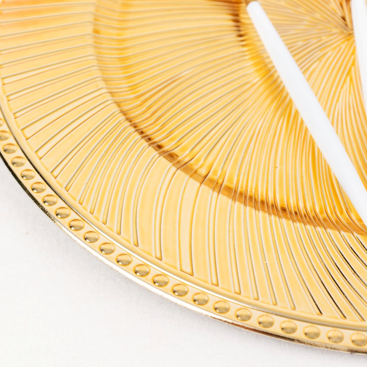 Metallic gold swirl pattern acrylic charger plate with beaded rim.