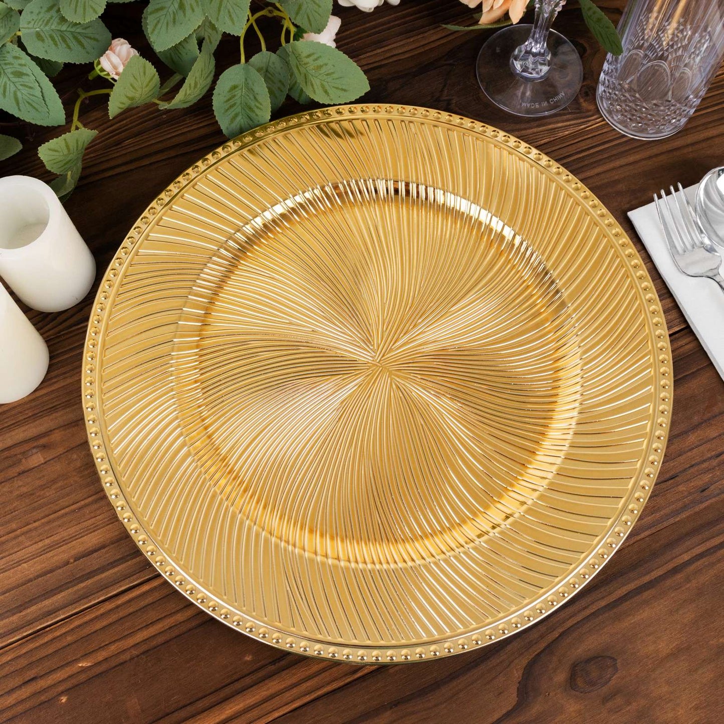Metallic gold swirl pattern round acrylic charger plate with beaded rim.