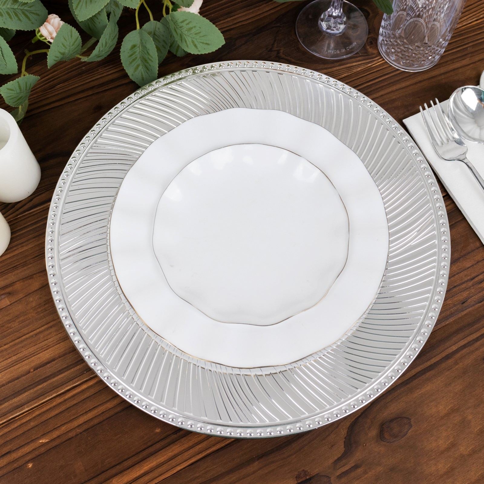 Metallic silver swirl charger plate with beaded rim, 13" unbreakable plastic.
