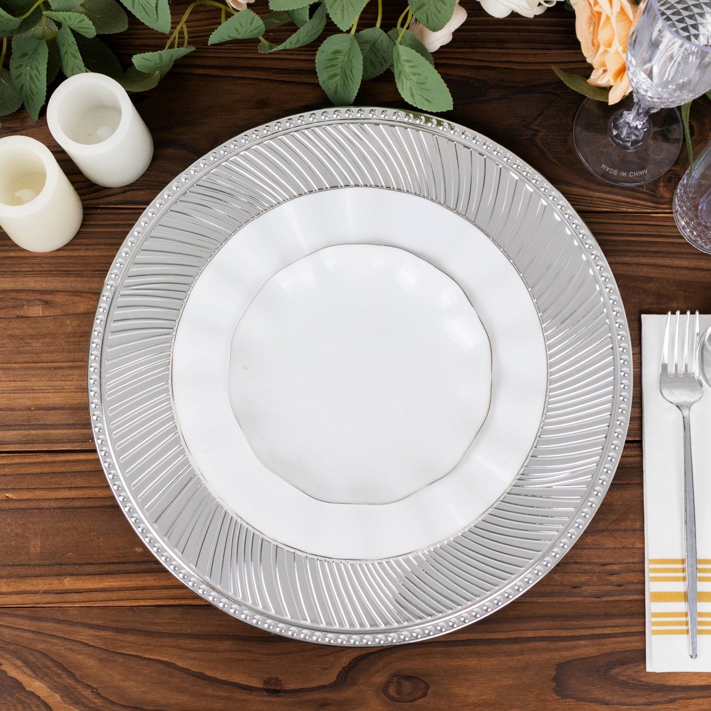 Metallic silver swirl pattern round charger plate with beaded rim.