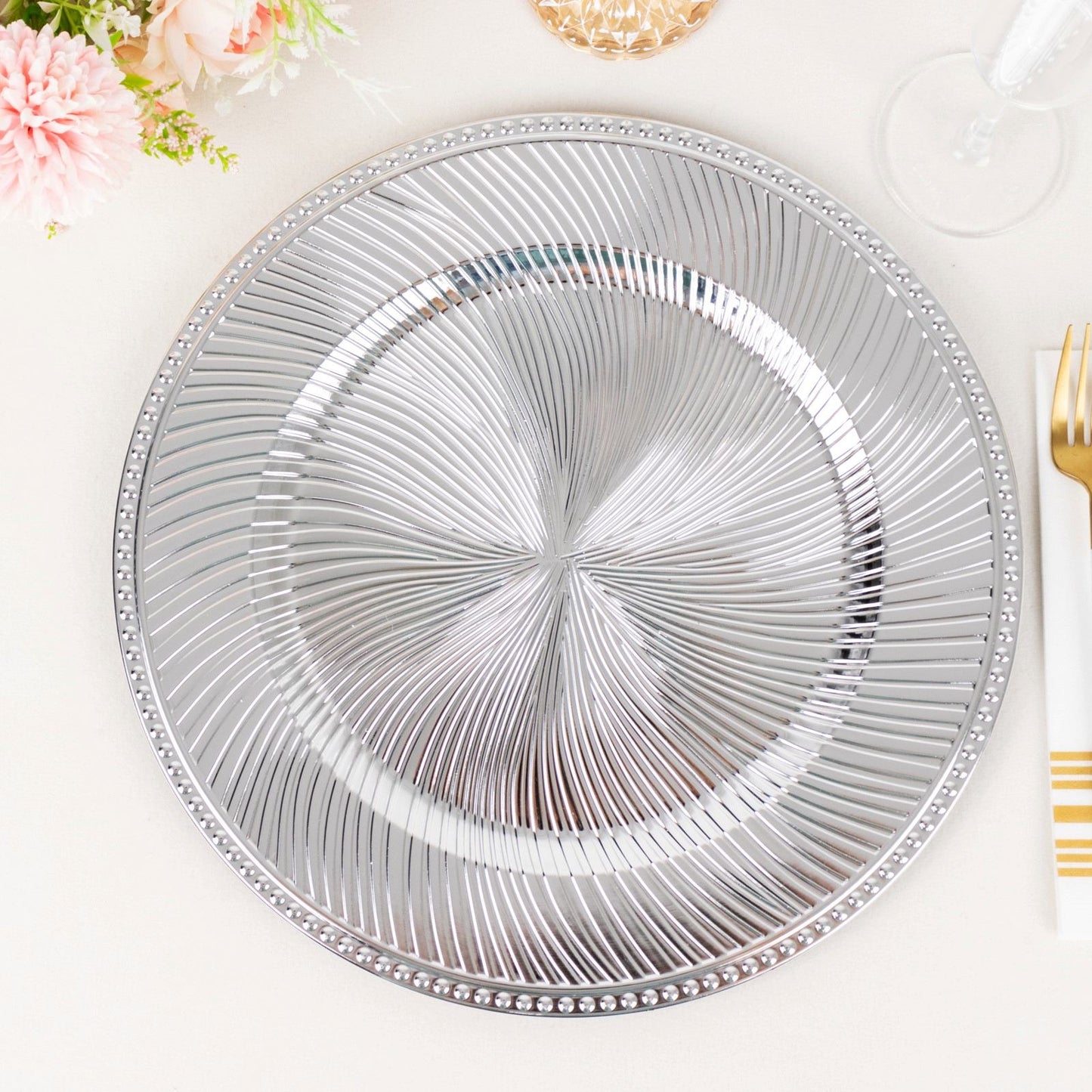 Metallic silver swirl pattern round acrylic charger plate with beaded rim.