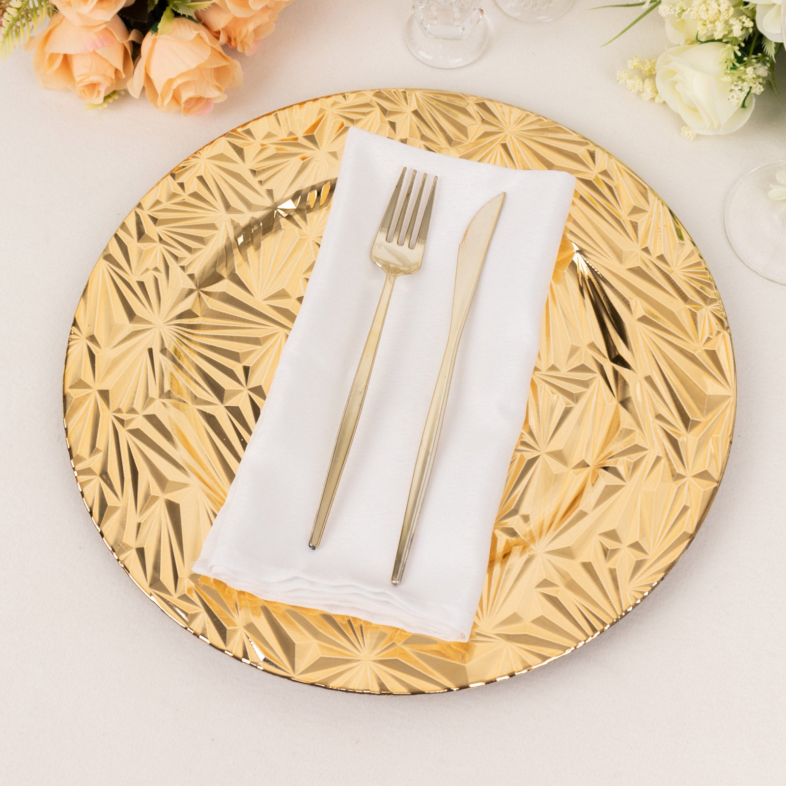 Metallic gold rock cut acrylic charger plate with utensils on a decorative table setting.