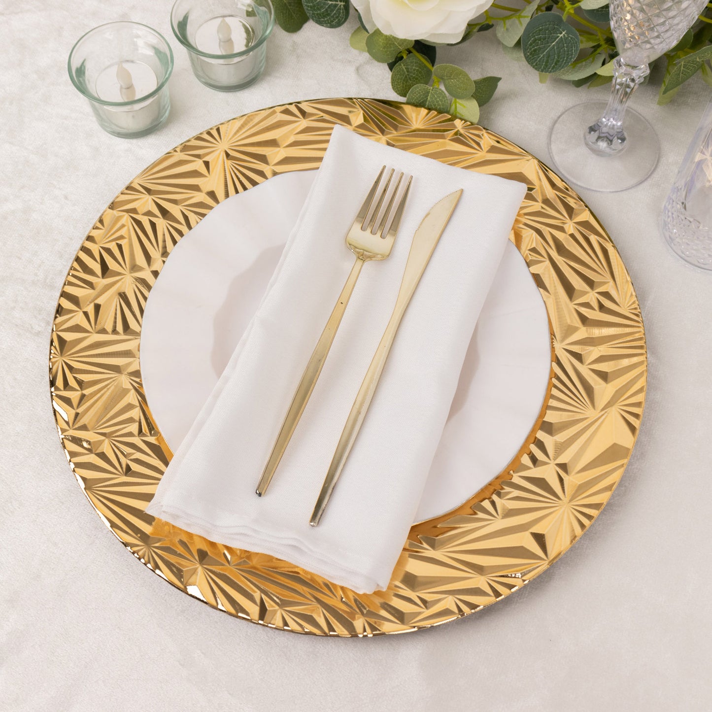 Metallic gold rock cut acrylic charger plate on a table setting.