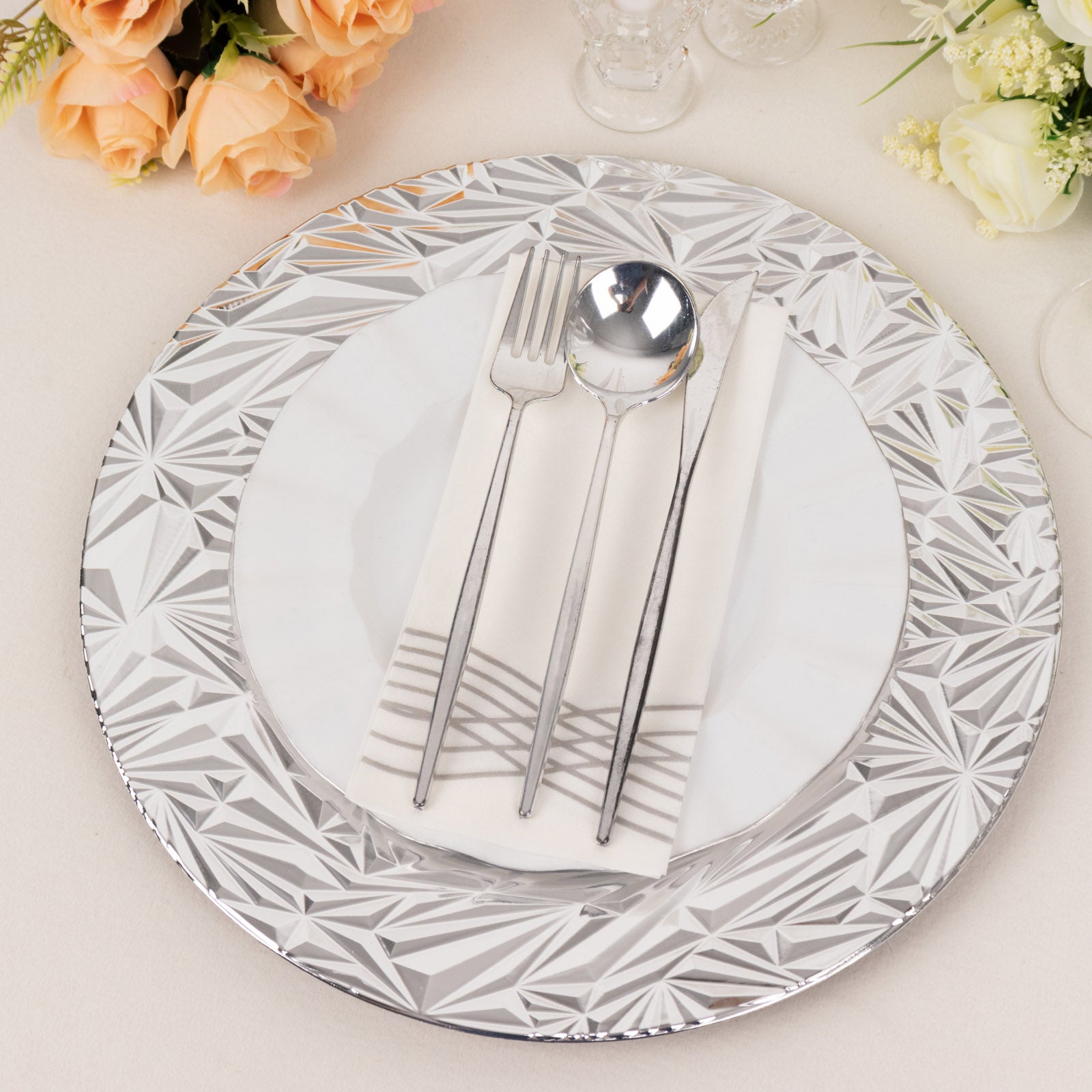 Metallic silver rock cut acrylic charger plate with elegant design.