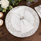 Metallic silver rock cut acrylic charger plate on a wooden table setting.