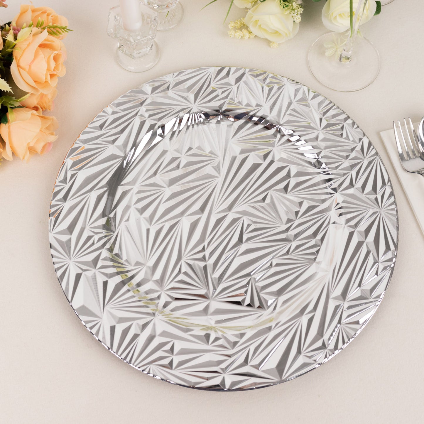 Metallic silver decorative charger plate with rock cut design.