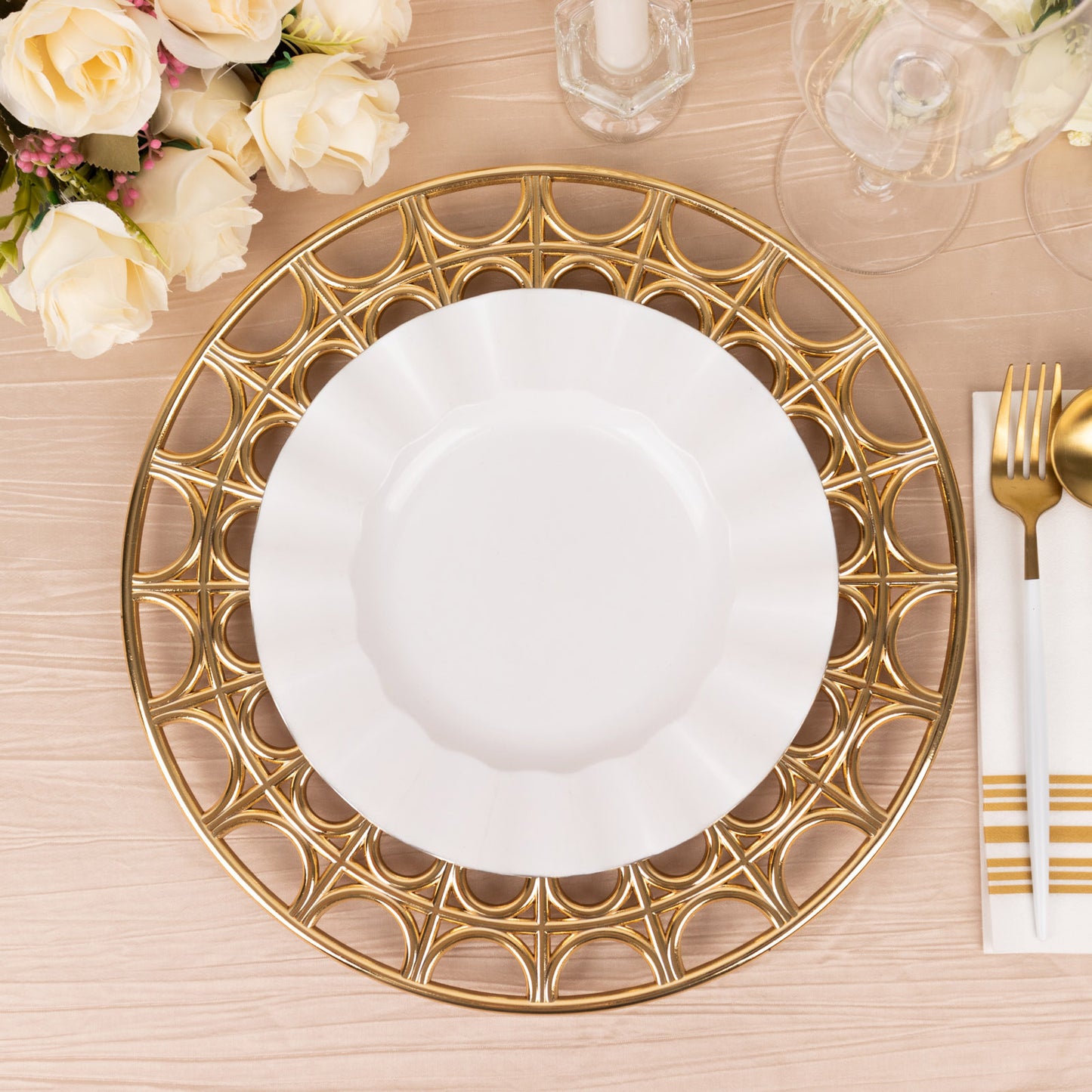 Metallic gold acrylic charger plate with hollow out rim on a table setting.