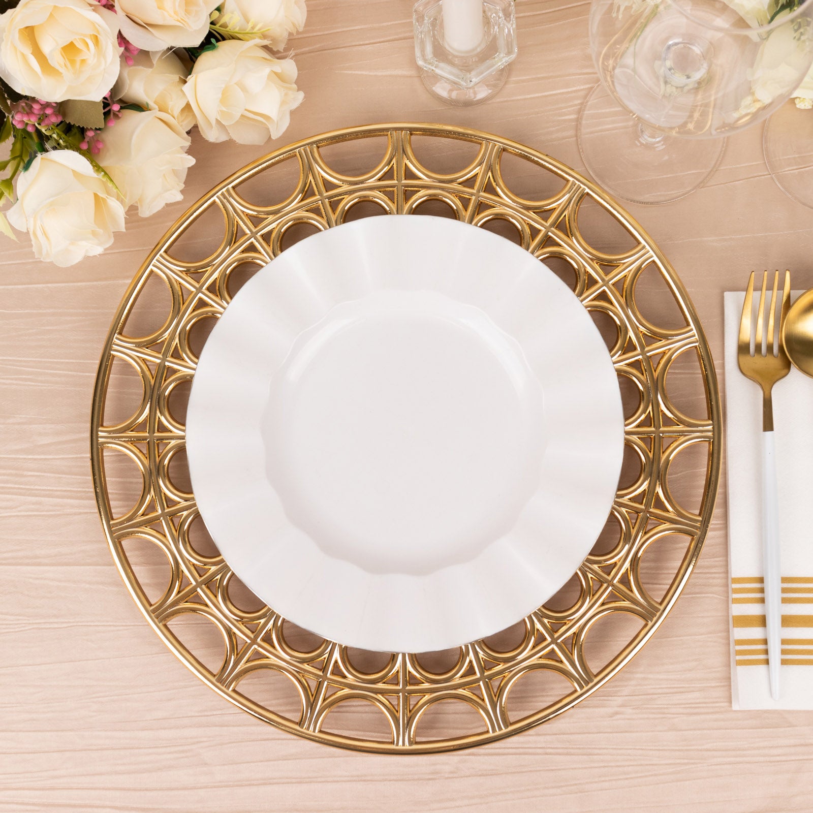 Metallic gold acrylic charger plate with hollow out rim on a table setting.